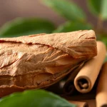 Detail of Cinnamon Bark surrounded by cinnamon sticks, showcasing its texture and natural warmth.